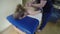 Girl have relax back massage. Masseur make strong fist movements