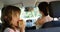 Girl having apple in the back seat of the car