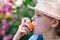 Girl having asthma using inhaler for being healthy - shallow depth of field