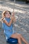 Girl having fun on a playground zip line on summer day