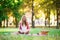 Girl having a picnic and writing in diary