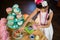 Girl having tea and confectionery at table during birthday party