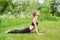 Girl having yoga practicing outdoors.