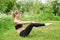 Girl having yoga practicing outdoors.