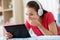 Girl in headphones listening to music on tablet pc