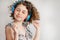 The girl in the headphones listens to music. Home music brings pleasure in isolation. The child dances and closes his eyes in