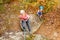 Girl in helmet abseiling training on steep rock