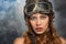 girl in helmet pilot and glasses on smoky background