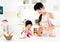 girl helping her mother prepare food in the kitchen