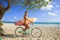 Girl on her bicycle with surfboard