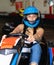 Girl and her friends competing on racing cars at kart circuit