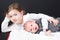 Girl with her little brother lying Playing children on floor on black background