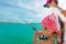 A girl and her mom fishing on a boat. Colorful tropical pattern