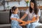 Girl and her mom involved in the toy airplane assembly