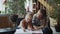 A girl and her mother draw together with colored pencils sitting in the living room