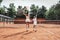 Girl with her mother play tennis on the tennis court