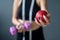 girl in her waist with a tape holding a apple in one hand and a dumbbell
