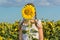 Girl hiding behind flower sunflower