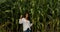 Girl in high corn plants field