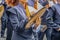 Girl in high school marching band playing the cymbals with determined looking chin - unrecognizable band members and motion blur