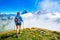 A girl during a hike in the mountains with poles sticks