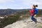 Girl hiker jumping and admiring the beauty mountains landscape in Quebec