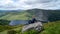 Girl hiker is looking at Guinness Lake Lough Tay -  a movie and series location, such as Vikings. Close to Dublin City,