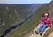 Girl hiker sitting on the summit of Acropoles des Draveures, Hautes-Gorges-de-la-RiviÃ¨re-Malbaie National Park