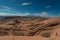 Girl Hiker walking down wavy sandstone towards the lake powell