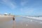 Girl hiking on the beach.