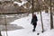 Girl hiking in cold, white winter.