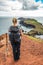 Girl hiking rocky cliffs clear near water of Atlantic Ocean bay Ponta de Sao Lourenco, the island of Madeira, Portugal