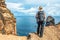 Girl hiking rocky cliffs clear near water of Atlantic Ocean bay Ponta de Sao Lourenco, the island of Madeira, Portugal