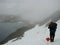 Girl hiking in snowfield and fog