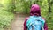 A girl hiking in a wooded path