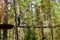 Girl on hinged trail in extreme rope Park