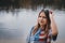 A girl hippy on the river bank posing and smiling