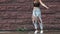Girl hipster in ragged jeans crazy dancing and sings under water splashes. girl is having fun walking around the summer