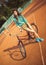 Girl hipster standing with magenta bike on the tennis court