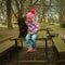 girl with his black schnauzer dog on a wooden bench