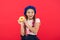 Girl hold glazed cute donut in hand red background. Kid smiling girl ready to eat donut. Sweets shop and bakery concept