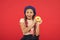 Girl hold glazed cute donut in hand red background. Kid smiling girl ready to eat donut. Sweets shop and bakery concept