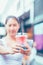 A girl hold refreshment water and straw in a glass