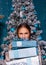 Girl hold Stacks of Christmas presents gift box on Christmas tree background