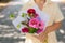 Girl holding beautiful bouquet of pink flowers.