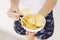 A girl holding the big potato chips bowl. Asking to eating together