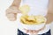 A girl holding the big potato chips bowl. Asking to eating together