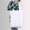 Girl is holding blank cotton tote bag, design mockup.