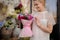 Girl holding a bouquet of crimson orchid and violet hyacinth