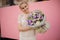 Girl holding bouquet of different purple flowers